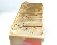 Bars of Tan colored soap with copper and green swirls on white background.